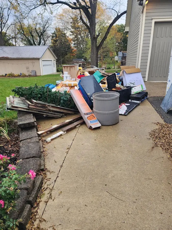 Dumpster being loaded with debris for Commercial Dumpster Rental in Indian Hills